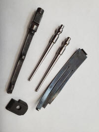 1911 parts 2-22-22_small A set of four different types of tools.