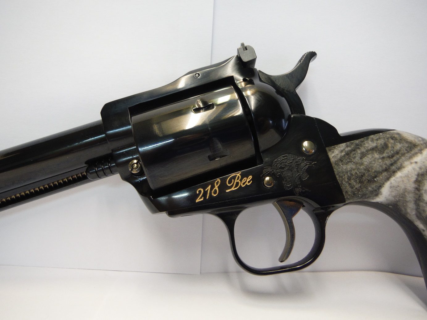A black revolver with gold lettering on it.
