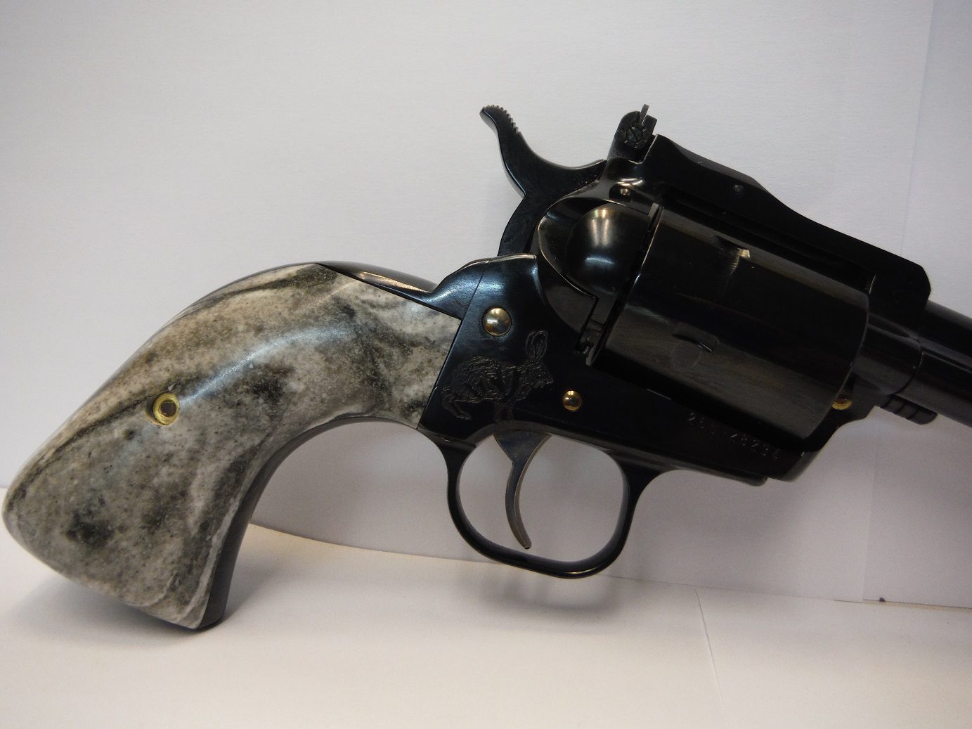 A black and white gun with a horn handle.