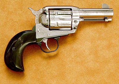 3 A silver and black gun is laying on the table