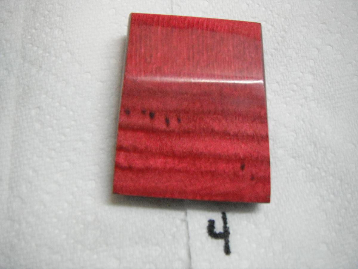 A red piece of wood with the number 4 written on it.