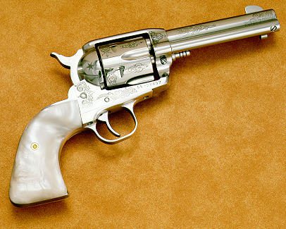 4 A silver gun with a shell on it's side.