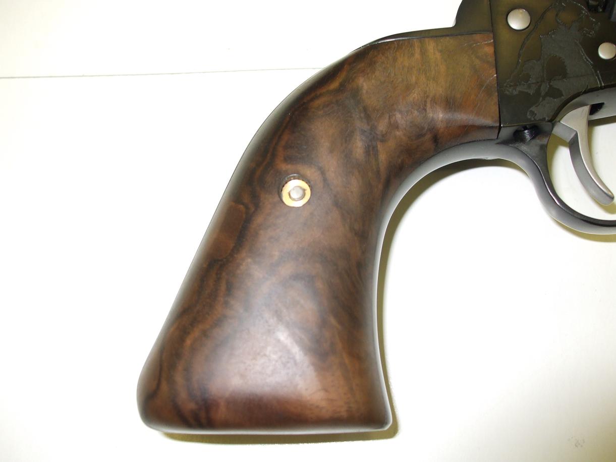A close up of the wood on the handle of a gun.
