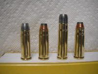 401 GNR_small Four different types of bullets are lined up on a table.