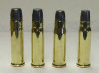 445 cartridges_small Four bullet casings are lined up in a row.