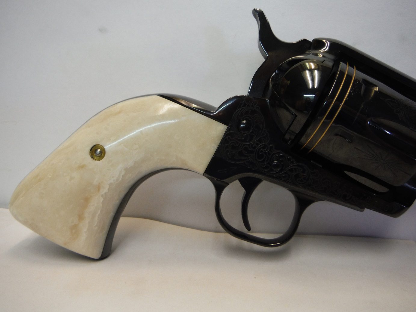 A black and white gun with a horn handle.