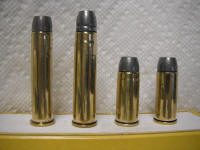 475 GNR, 476 GNR, 500 GNR, 510 GNR_small A group of four bullet casings sitting on top of a table.