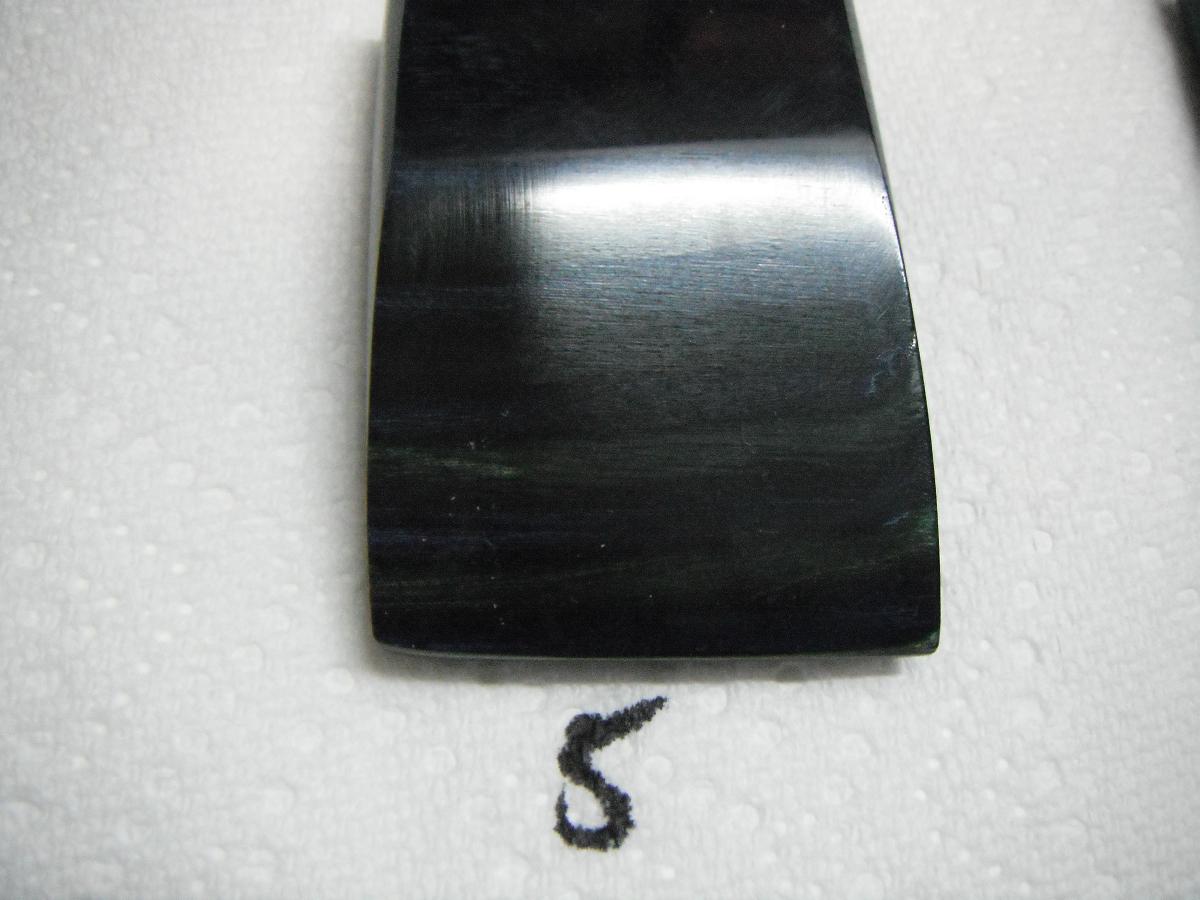 A black piece of metal with the number 5 written on it.