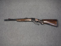 500-1 - Copy_small A rifle that is sitting on the ground.