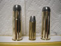 586 GNR, 45 Long Colt, 610 GNR_small Three different size bullet shells on a shelf.