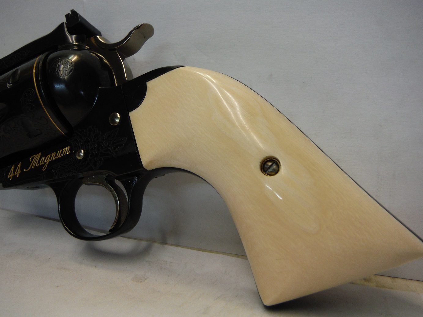 A white gun with black handle and back.