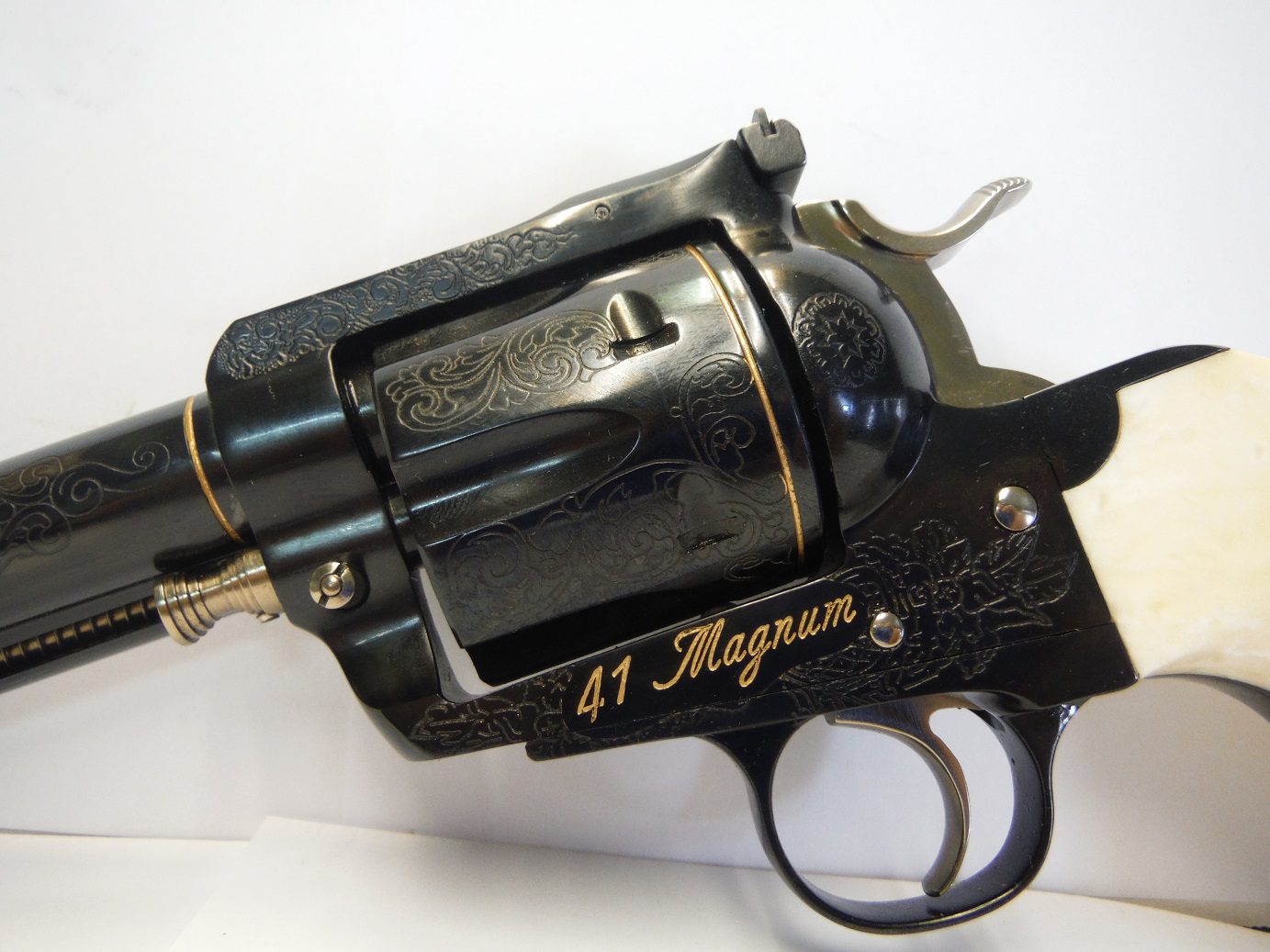A black and gold gun with the words " 4 1 magnum ".