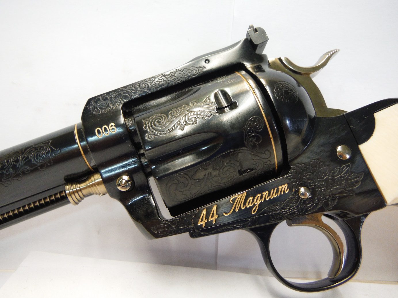 A black and gold gun with the words " 4 4 magnum ".