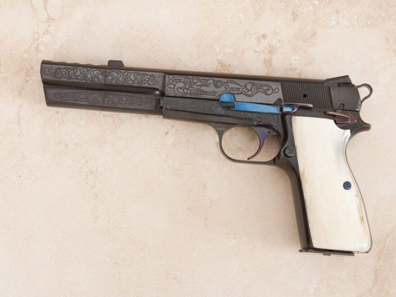 A gun that is on the ground with some blue accents.