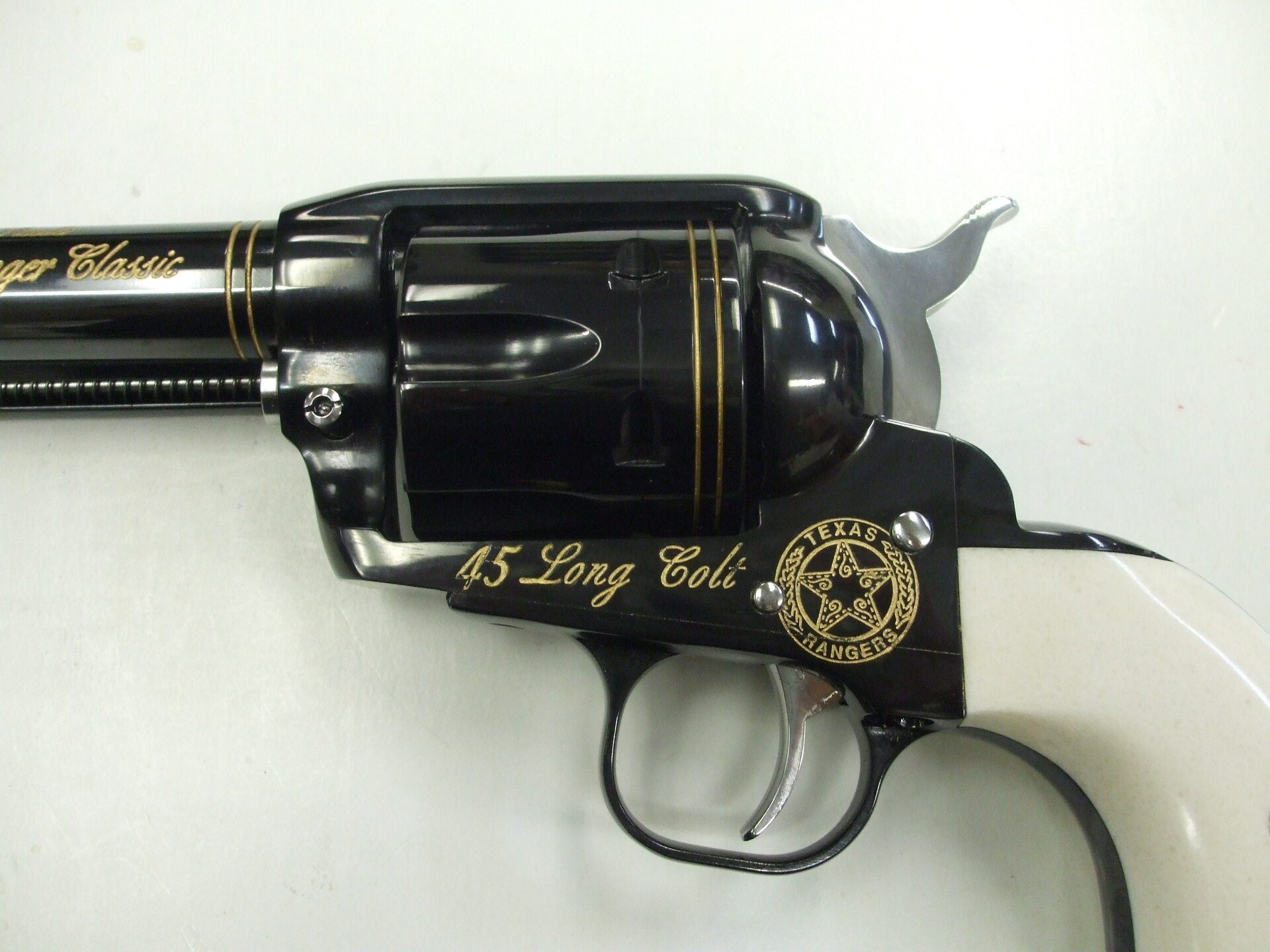 A black and white colt 4 5 with gold accents.