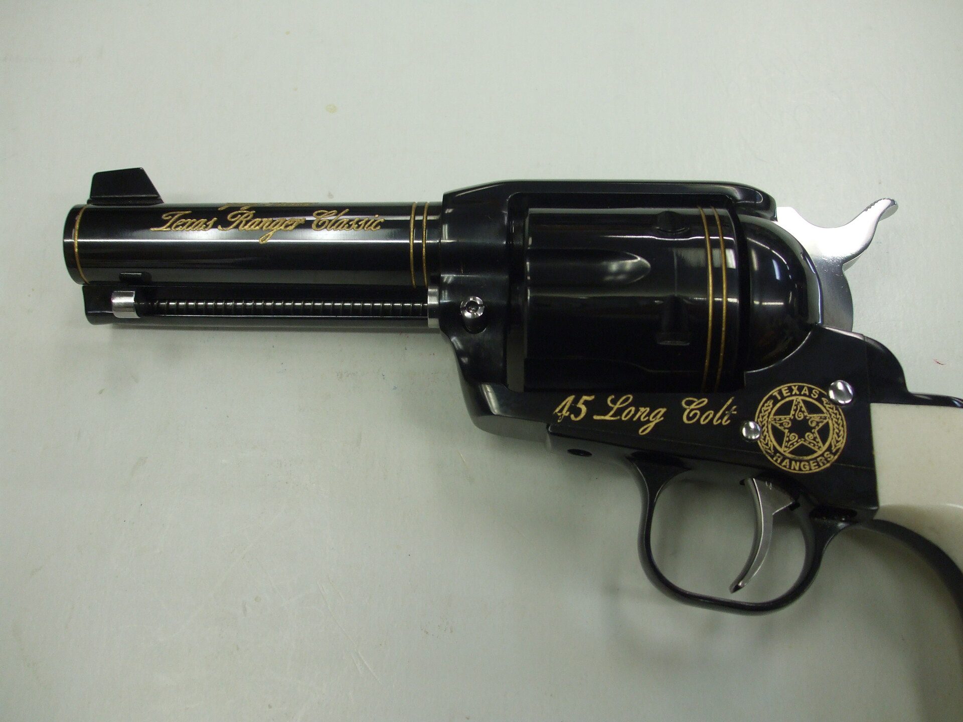 A black and gold gun with the words " 6 5 day no. 1 ".