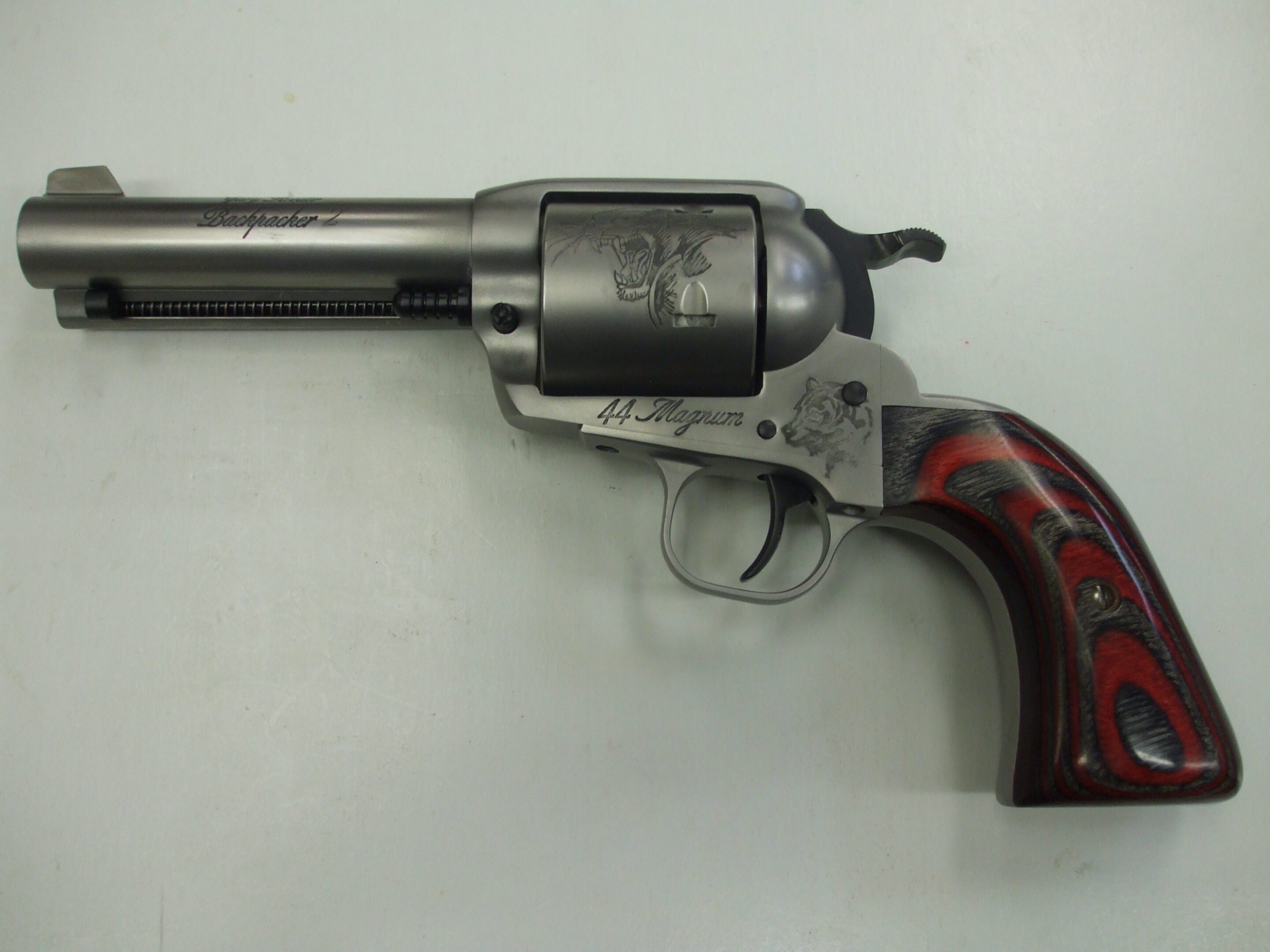 A gun that is on the ground with its handle up.