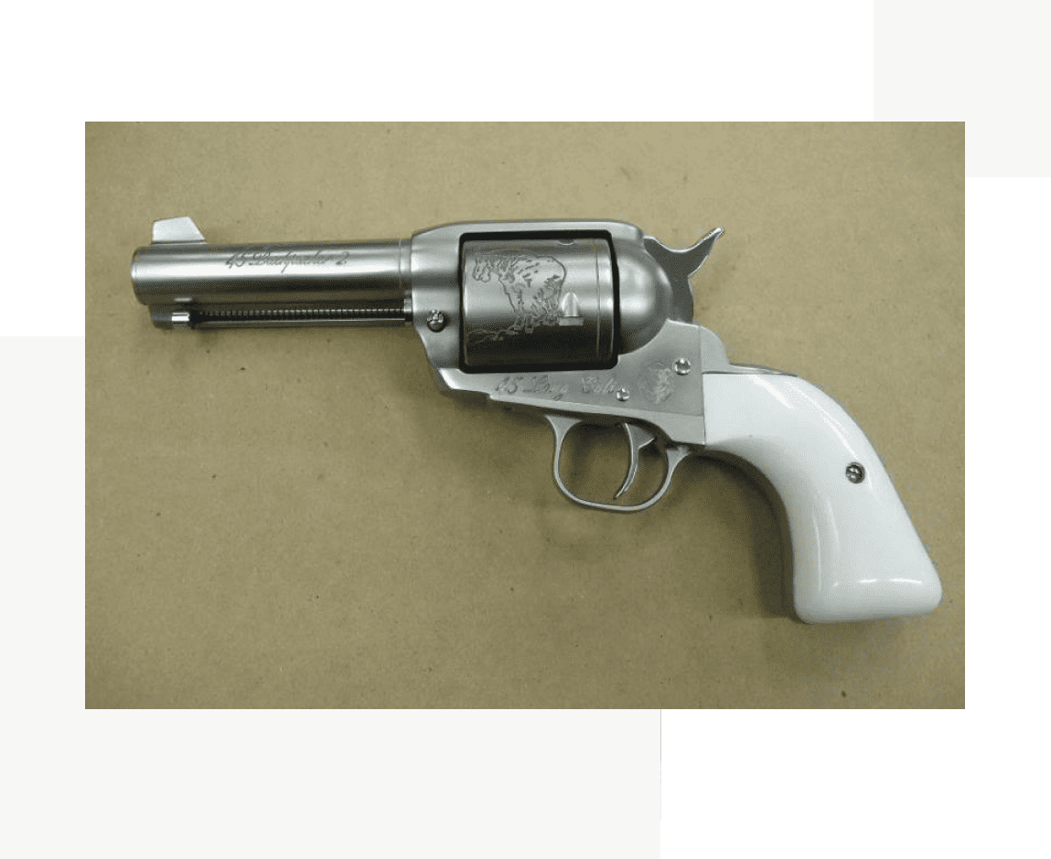Group 18 A silver and white gun is on the table.