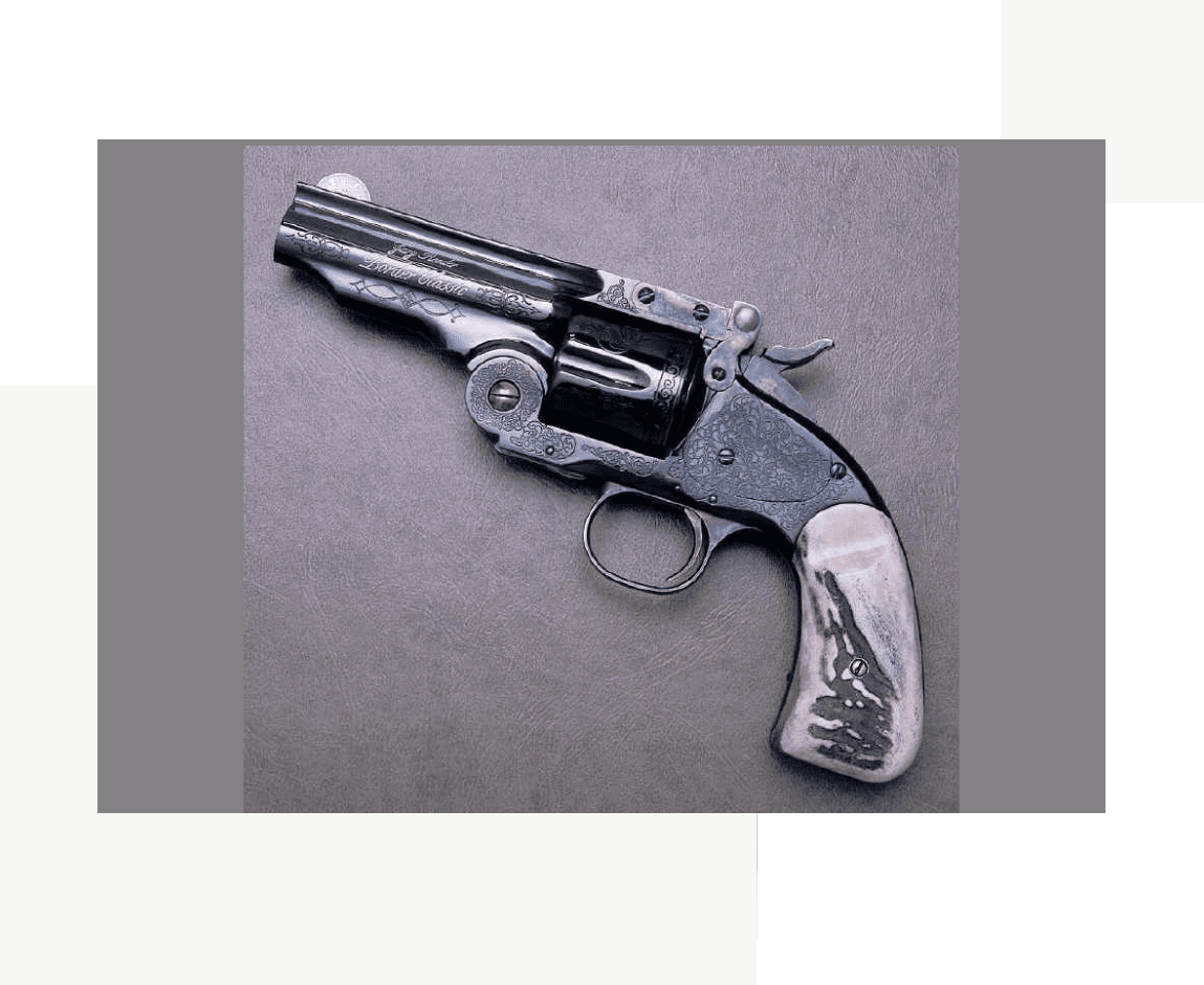 Group 21 A gun with a silver handle and the top of it.