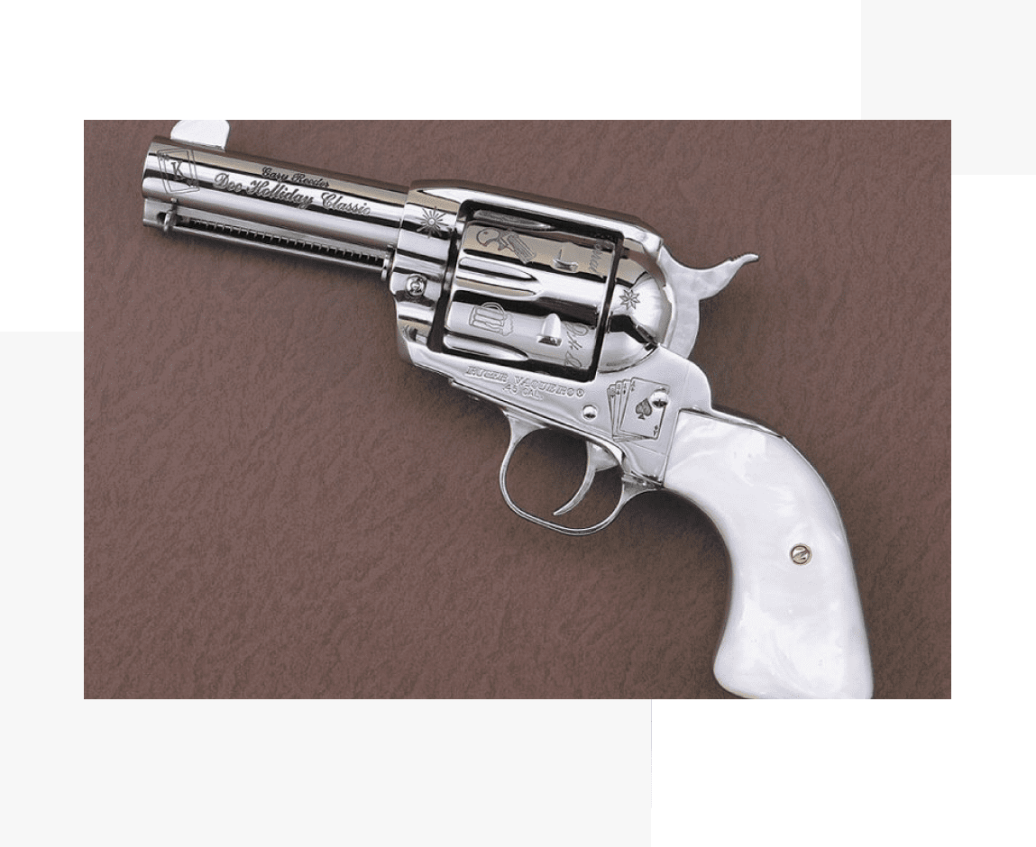 Group 29 A silver gun with white grips on top of brown surface.