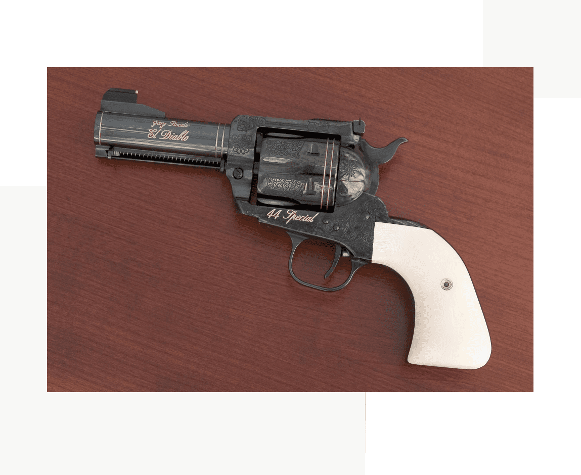 Group 32 A black and white gun is on top of a table.