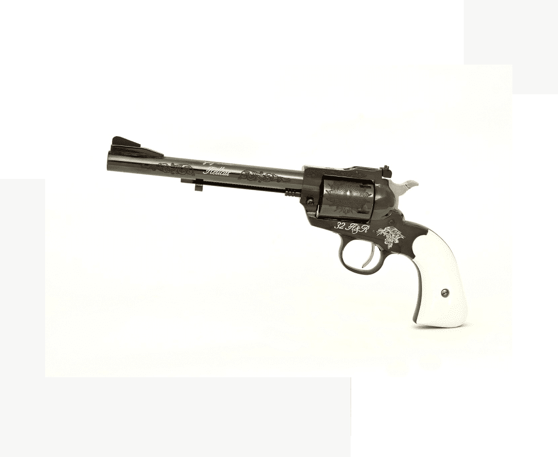 Group 38 A gun that is on the ground with a white handle.