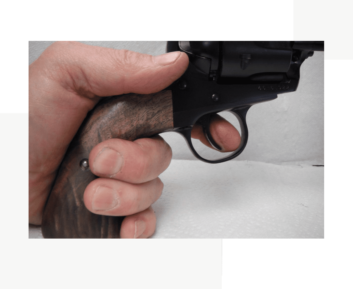 Group 42 A person holding a gun in their hand.