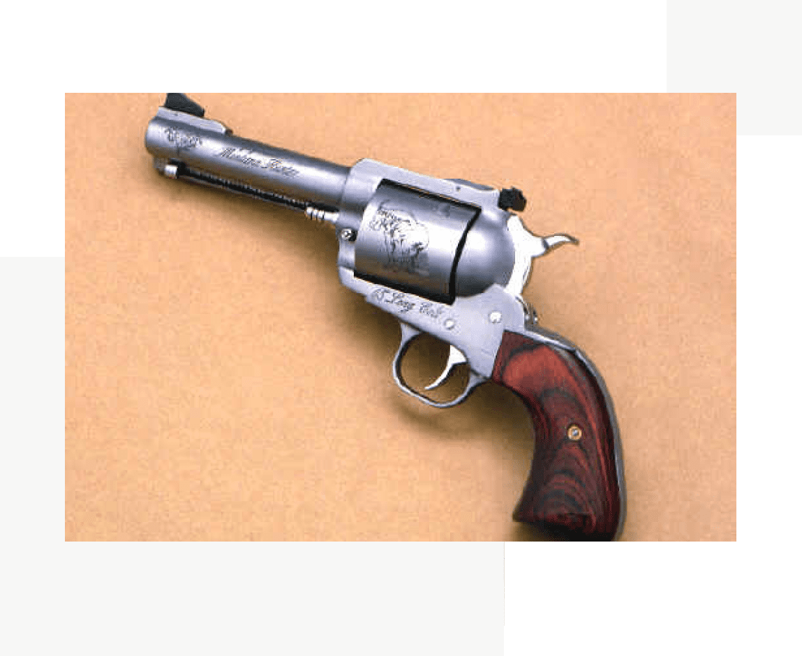 Group 44 A silver and wood gun is on the table.