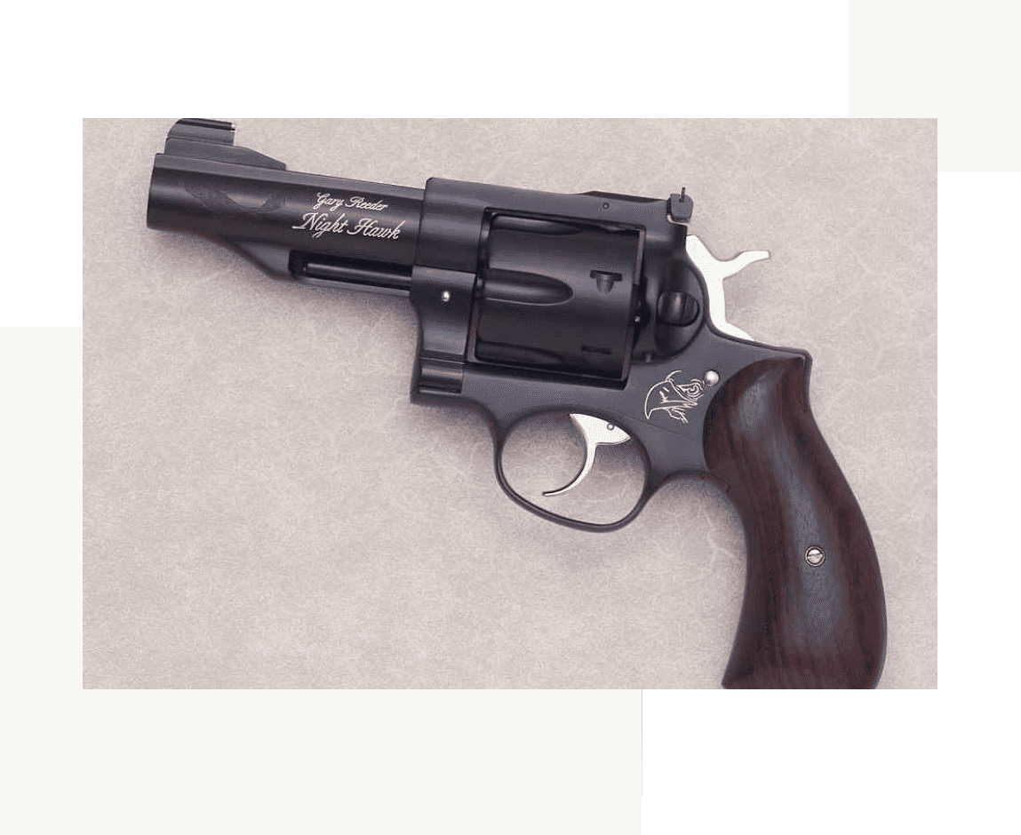 Group 46 A black revolver with a wooden handle on the side.
