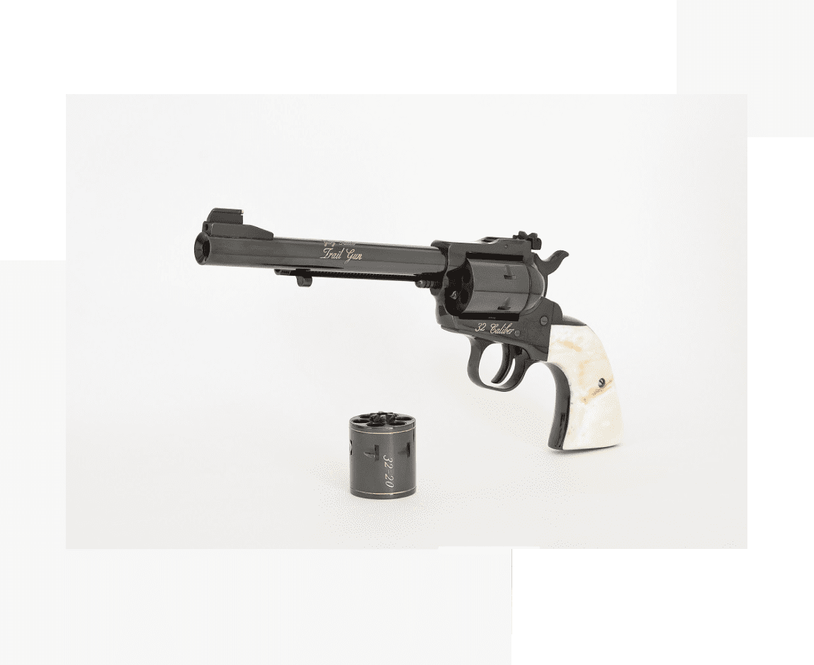 Group 63 A toy gun and bullet hole in the middle of a table.