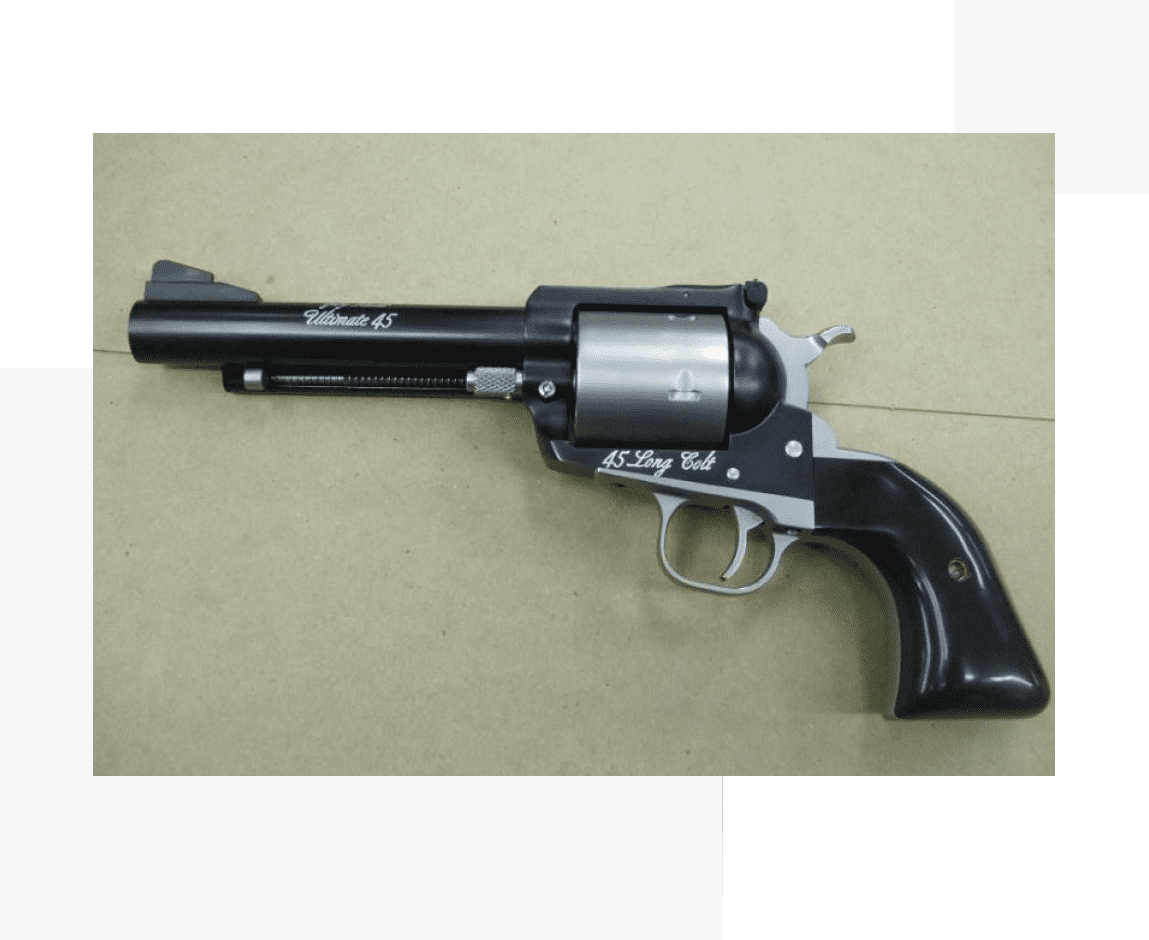 Group 69 A black and silver gun is on the floor