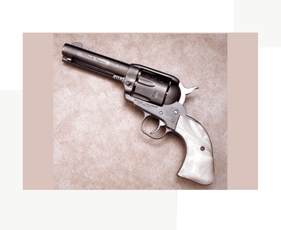 Group 73 A gun with a white handle and a black barrel.