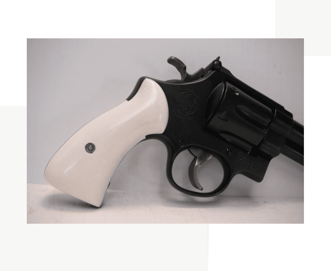 Group 75 A white handle on a black gun