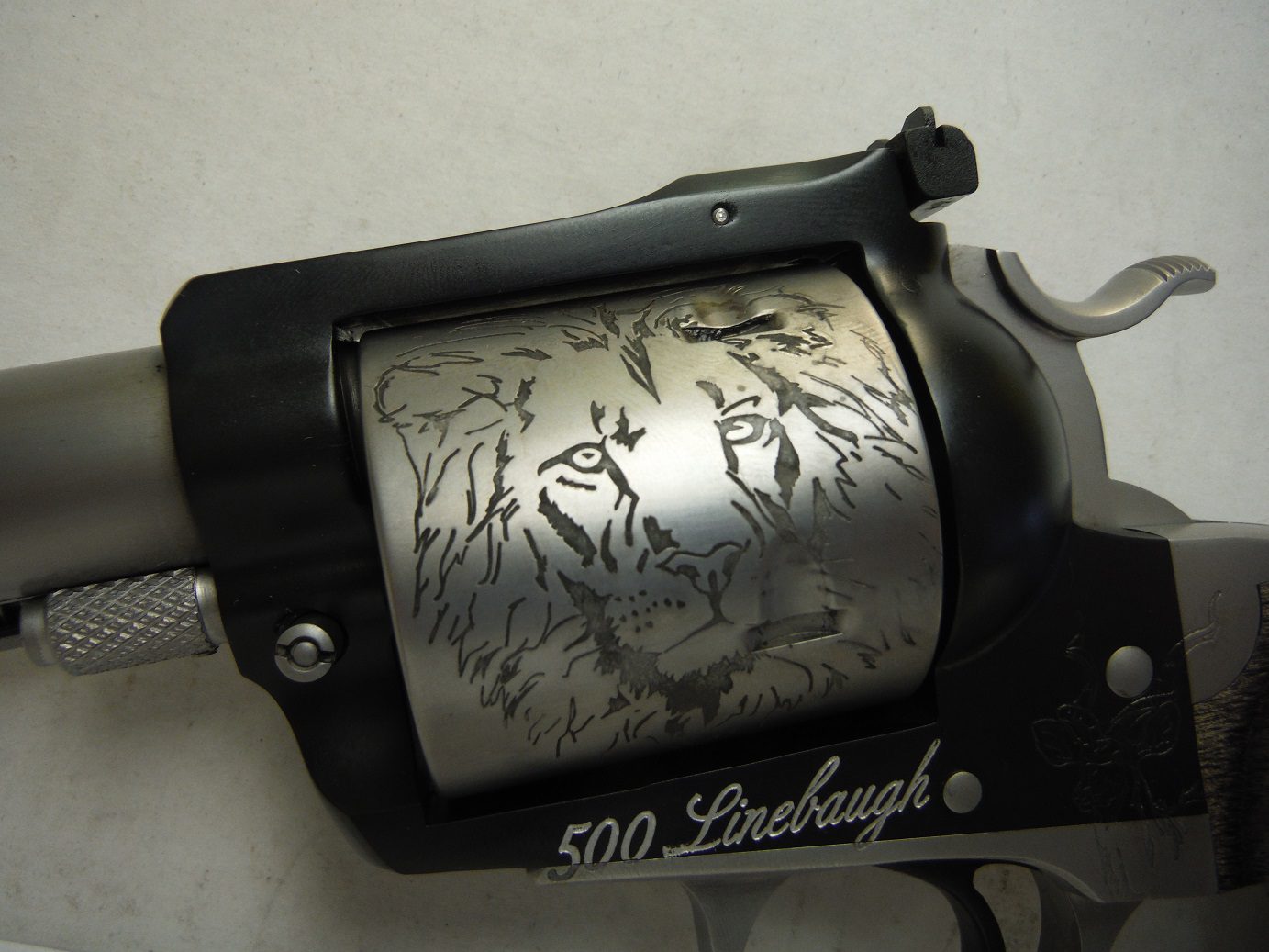 A gun that has been engraved with animals.