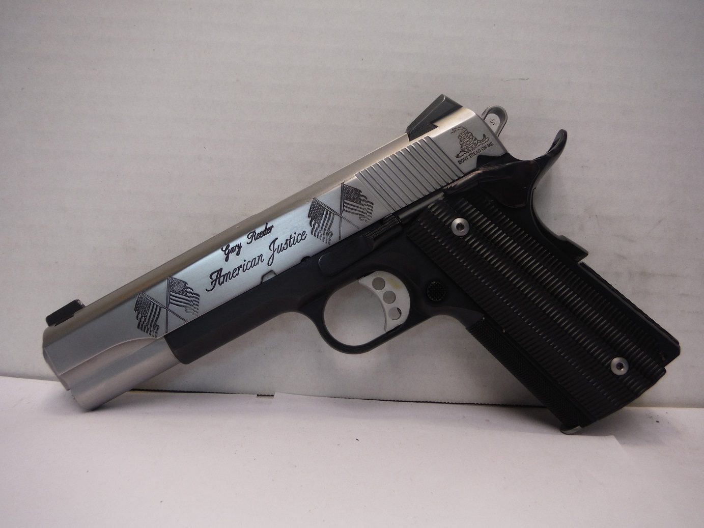 american-5 A gun that is sitting on top of a table.