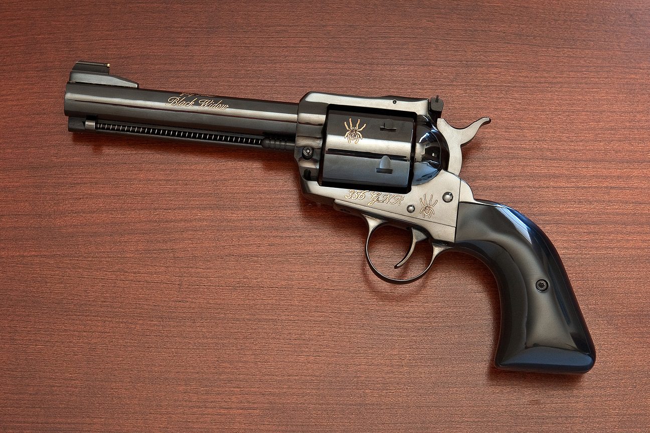A gun that is sitting on top of a table.