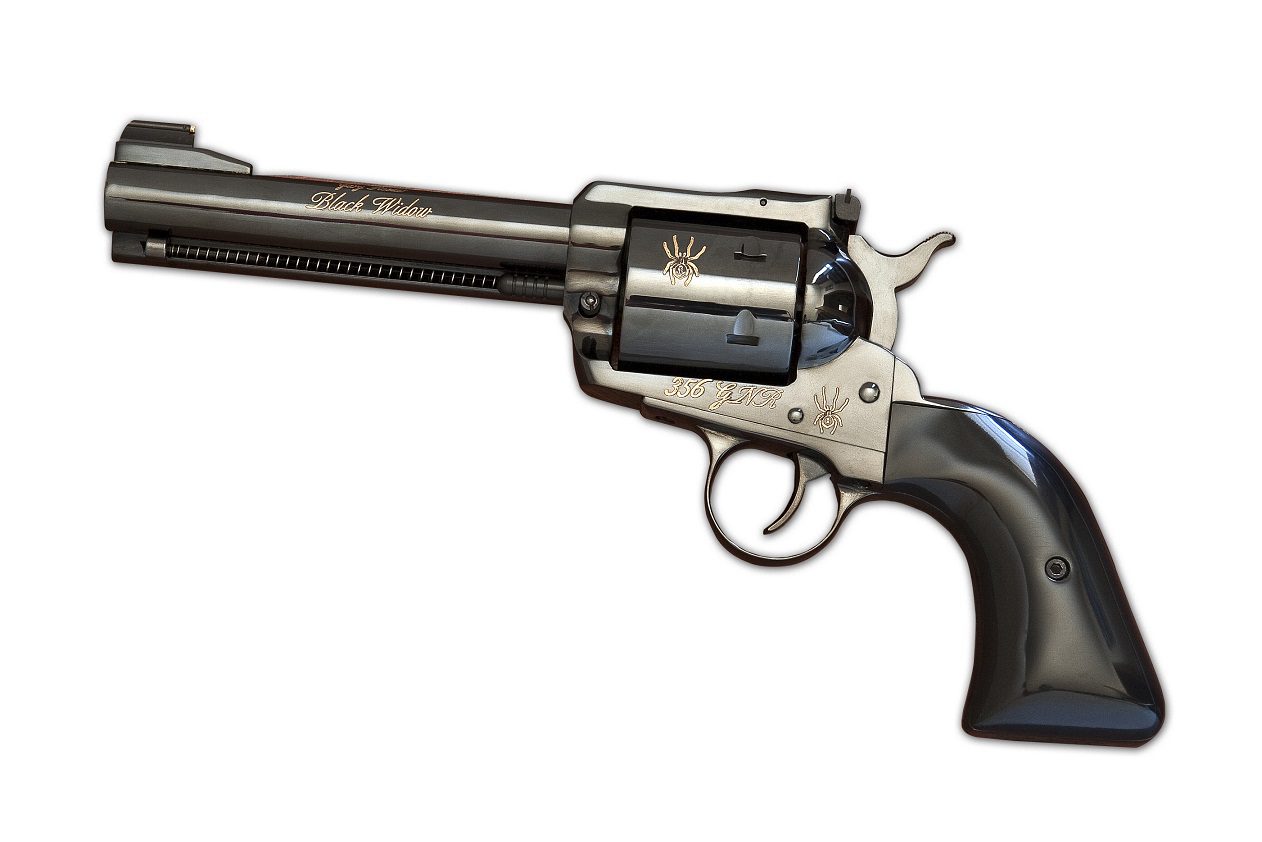 A gun that is on the ground with its barrel pointed up.