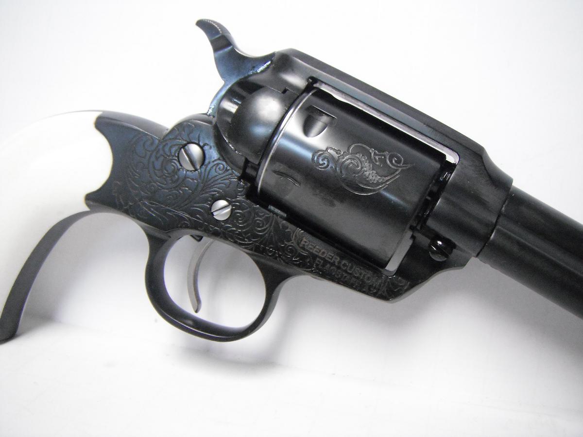 A black revolver is shown with the handle extended.