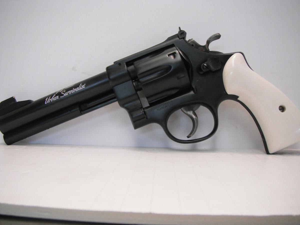 A black and white revolver is on the table