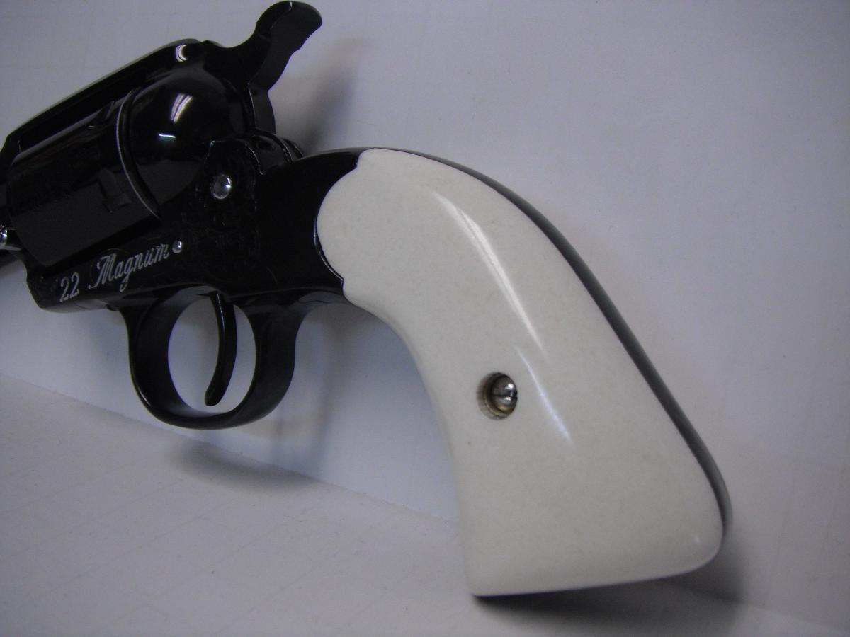 A white and black gun is on the wall