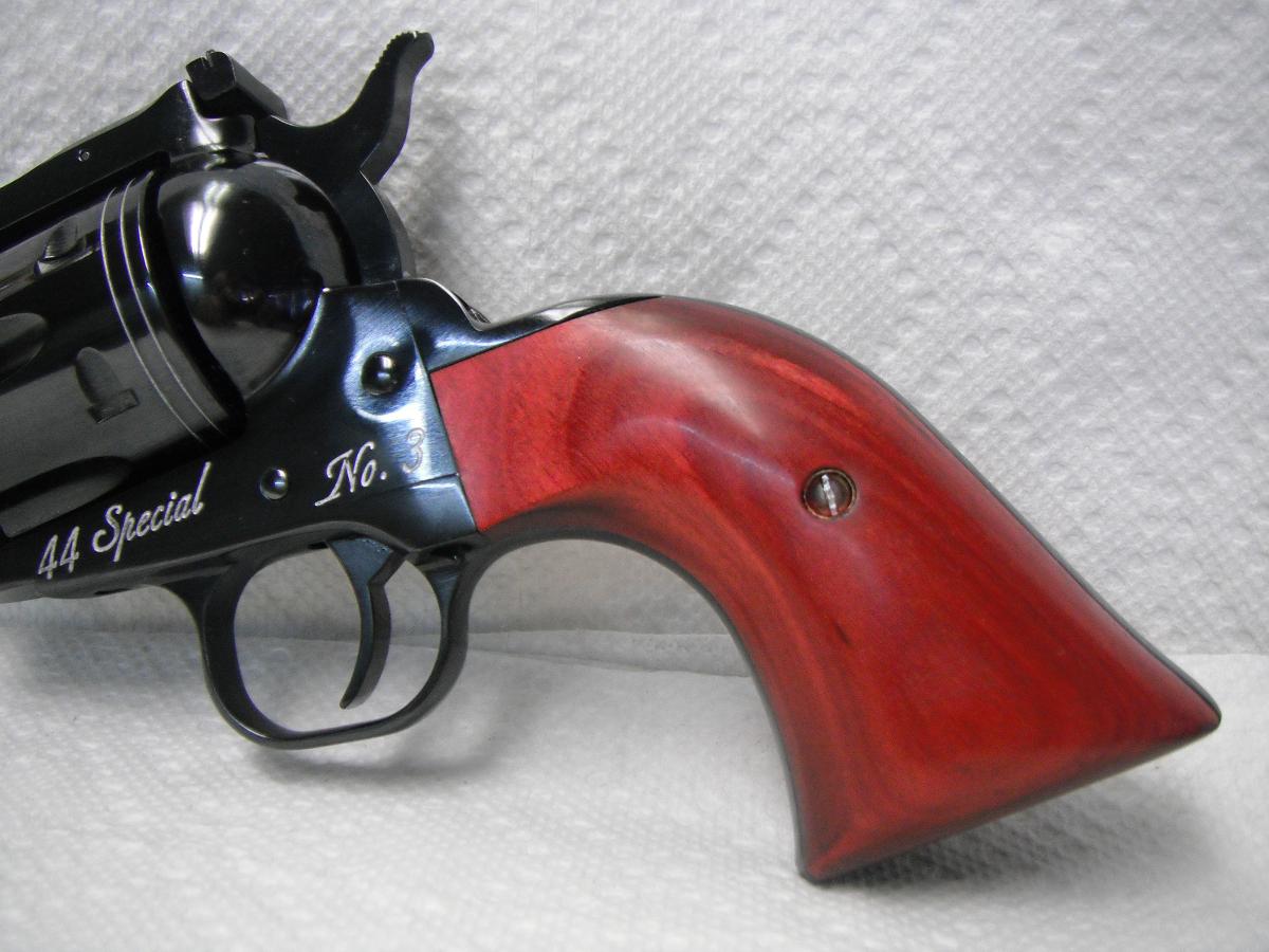A red and black gun is on the table