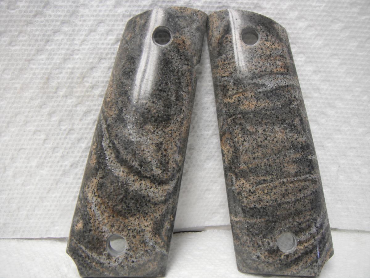 A pair of granite grips are sitting on top of a white sheet.