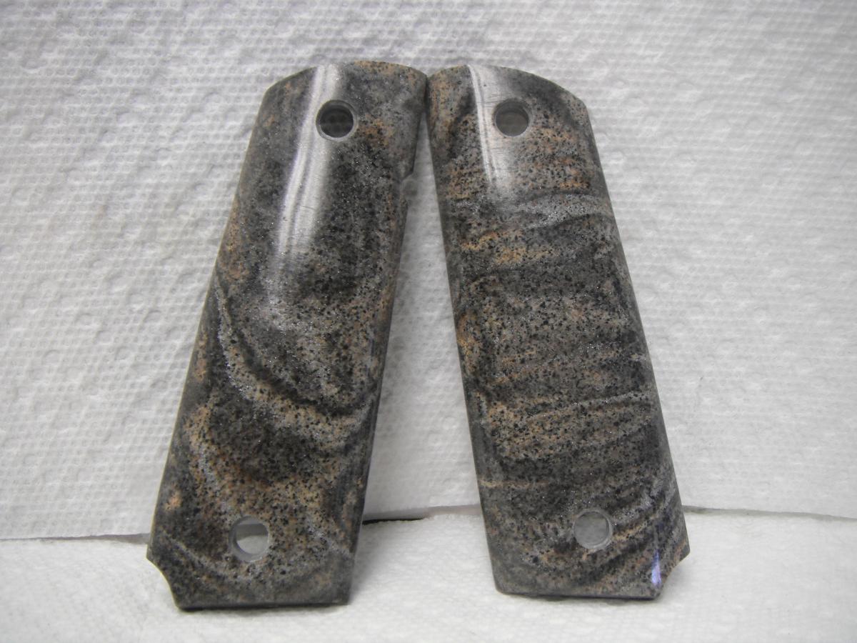 A pair of granite grips for a gun.