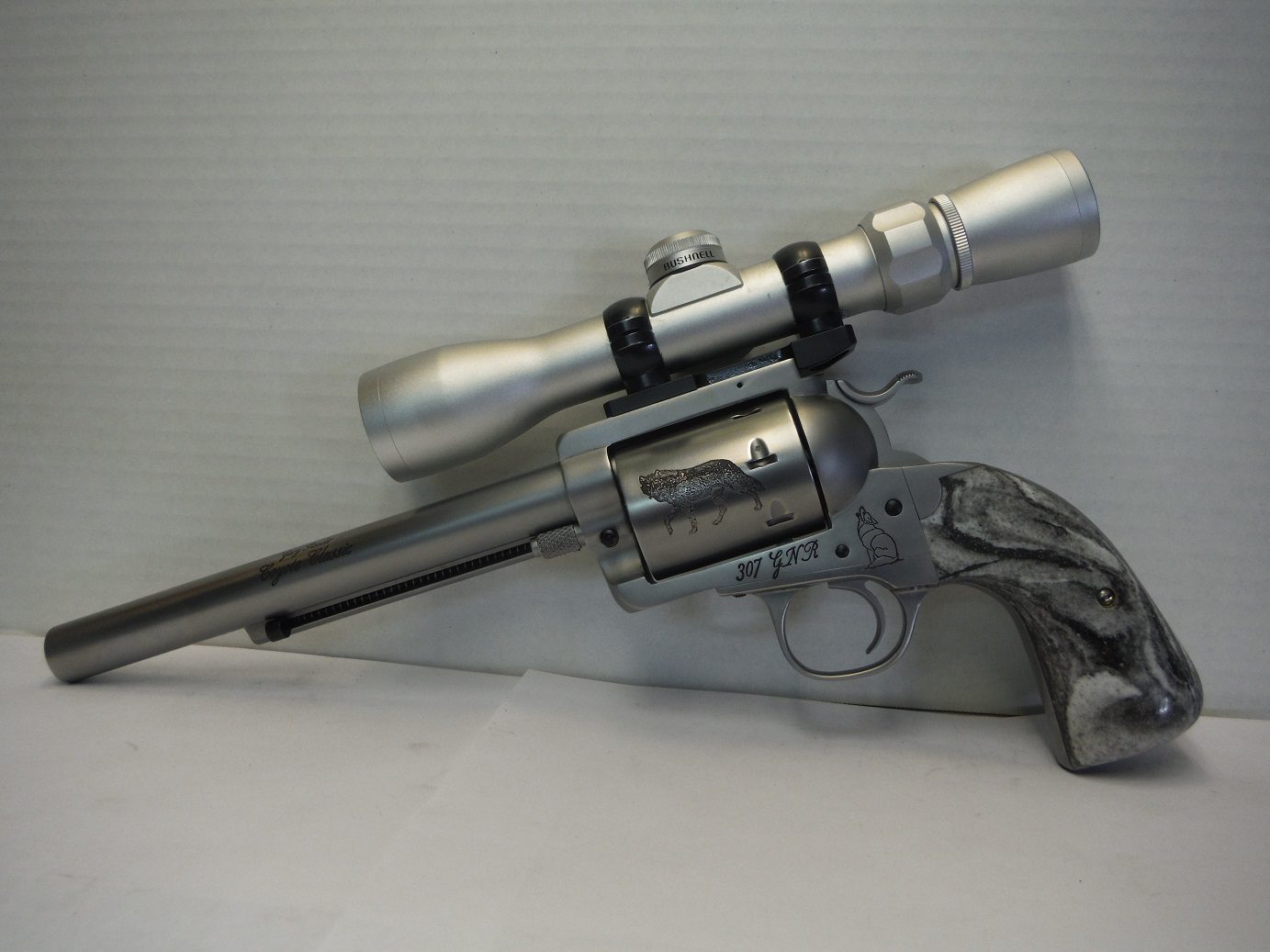 A gun with a scope on it's side.