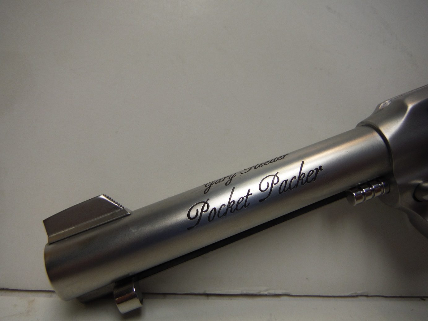 A silver pen with the words " pocket book ".