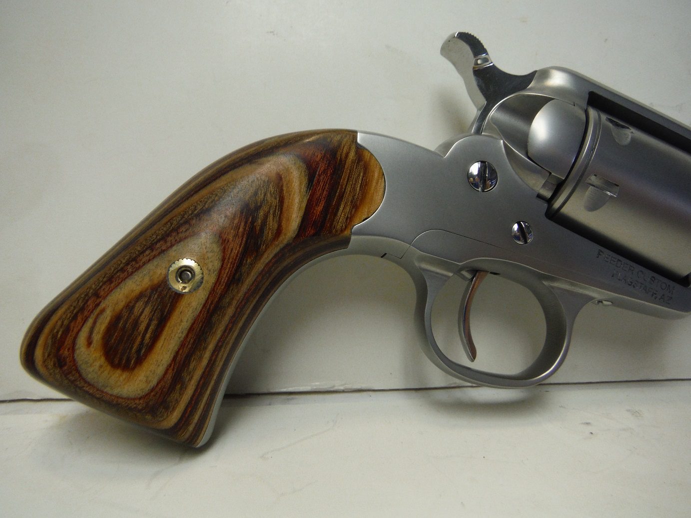 A close up of the handle on a gun