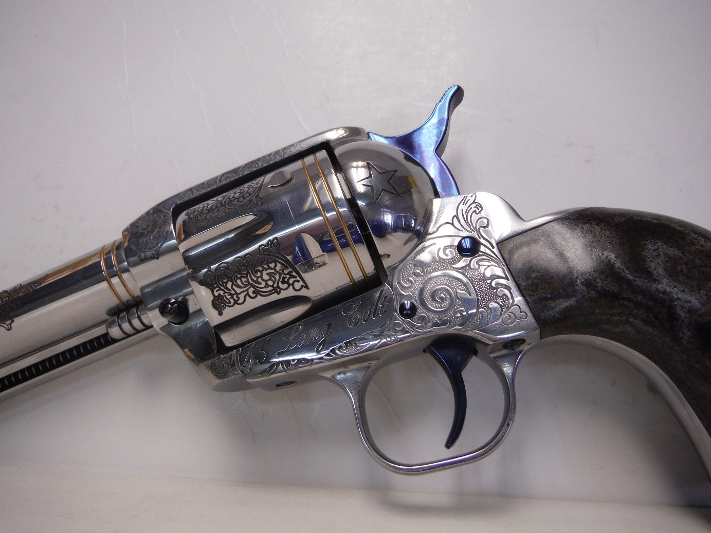 A gun that is on the ground with its barrel pointed up.
