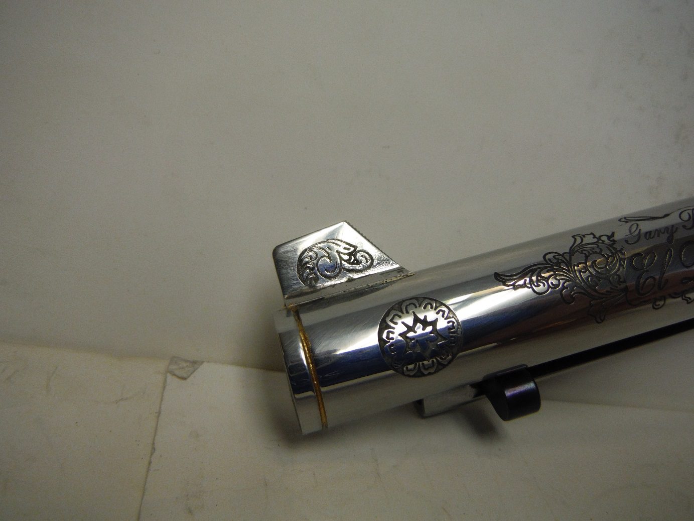 A close up of the side of a silver gun