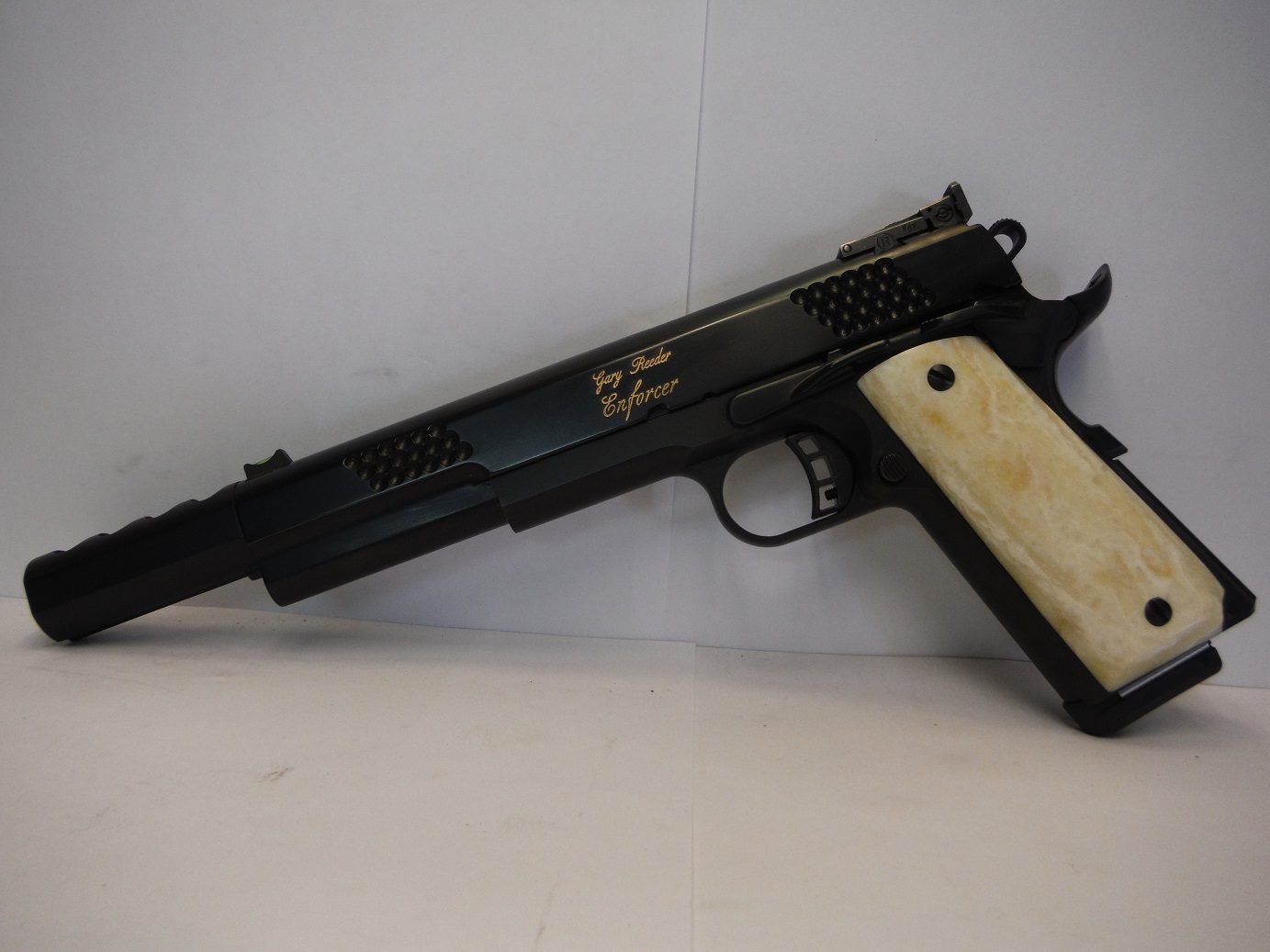 A black and white gun is sitting on the table