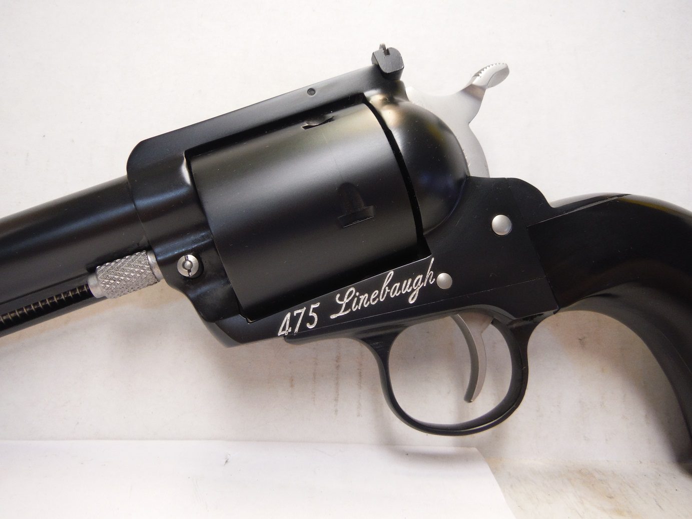 A black revolver with the words " let 's looong !" on it.